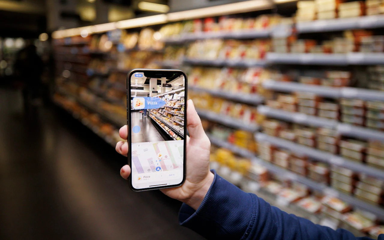 Someone using a smartphone AR app to guide them through a supermarket.