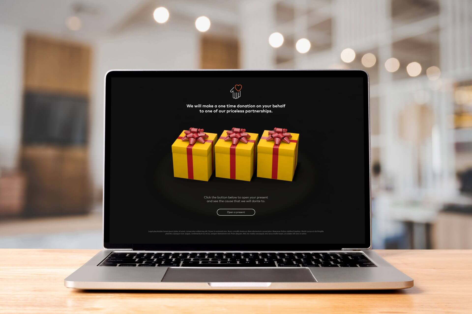 A laptop displaying a creative immersive campaign for Mastercard, an image of 3 yellow gift boxes with red bows on a black screen.