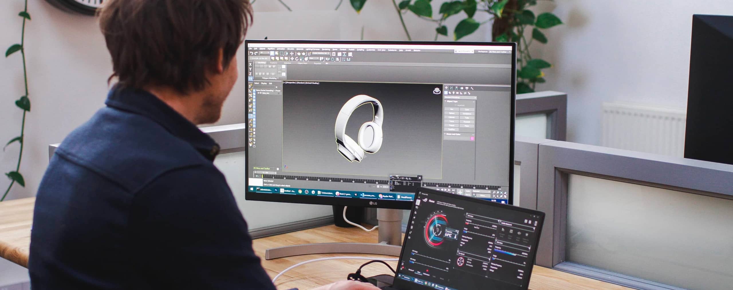 An over shoulder shot of a 3D artist modelling 3D headphones in software.