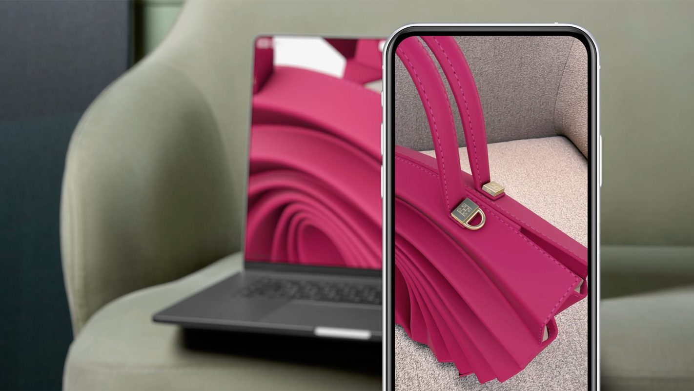 A smartphone and a laptop displaying the virtual AR product model of a Thaden handbag.
